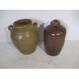 A large two handled glazed terracotta urn along with a large flagon