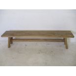 A rustic wooden bench - overall length 195cm