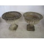 A pair of concrete garden urns