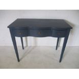 A serpentine fronted side table with 3 drawers