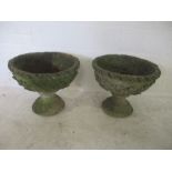 A well weathered pair of garden concrete urns