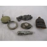 A small collection of items including a double horn whistle, compass and magnifying glass
