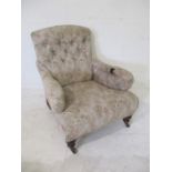 A Victorian button-back armchair