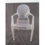 A Louis Ghost by Kartell transparent chair.