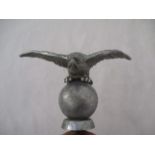 A Desmo cast metal car mascot modelled as an eagle on a ball