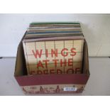 A collection of 12" vinyl records including Wings, Simon & Garfunkel, ABBA, Sting, Styx, John