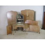 A Wrighton bedroom suite comprising of two wardrobes, kidney shaped dressing table, one bedside
