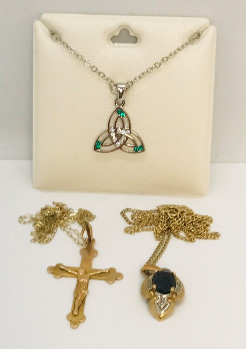 A 9ct gold Crucifix on fine chain, a 9ct gold sapphire and diamond pendant on chain and an SCM