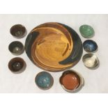 A large Eden pottery charger along with a collection of studio pottery bowls