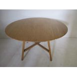 An Ercol drop leaf table with cross stretcher