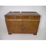 An Art Deco sideboard with two drawers and cupboard under