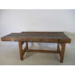 A rustic kitchen table with planked top