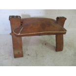 A leather topped camel stool