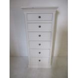 An upright chest of six drawers H145cm W65cm D48.5cm