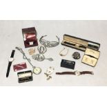 A collection of costume jewellery, watches etc. including a tie clip in the form of a cricket bat,