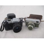 A Rolleiflex SL35 camera along with a Carl Zeiss Jena Werra camera, with olive green body and fitted