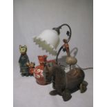 A slipware puzzle jug, Art Nouveau style lamp, wooden animals etc.