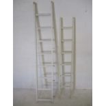 Two white painted ladders