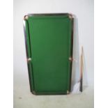 A Slatex snooker table (overall size -145cm x 77cm) by Walter Briggs Ltd, along with two cues and