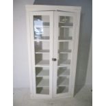 A large white painted two door display cabinet - height 186cm, width 95cm, depth 37cm