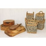 A collection of wooden chopping blocks and boards along with an assortment of wicker baskets