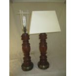 Two large table lamps on turned wood, height 55cm.