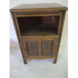 An oak bedside cabinet with Gothic arch decoration