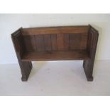 A pitch pine church pew with gothic decoration to ends