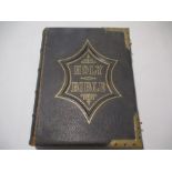 A Victorian family Bible, leather bound with brass clasps.