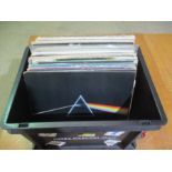 A collection of 12" vinyl records including Pink Floyd, Queen, The Eagles, The Beatles, The Moody