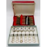 A boxed set of Chinese design Sterling silver coffee spoons along with one other set