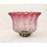 A turn of the century cranberry glass oil lamp shade