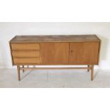 A mid-century sideboard with three drawers and cupboard under