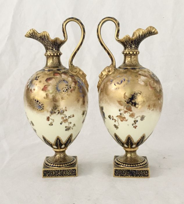 A pair of Royal Crown Derby mask handled Jugs of bulbous form in the Imari palette with Oriental