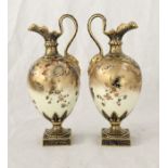 A pair of Royal Crown Derby mask handled Jugs of bulbous form in the Imari palette with Oriental