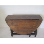 An antique oak & elm drop leaf table