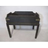 An ebonised butlers tray on stand.