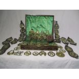A collection of various horse brasses in leather covered cutlery box