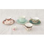 A collection of Royal Crown Derby teacups and saucers including a green and gilt bird/finch