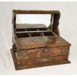 A Victorian oak tantalus with silver plated mounts and two hinged doors enclosing two