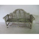 A lichen covered Lutyens style bench, width 165cm