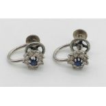 A pair of 9ct white gold earrings each set with a diamond and sapphire cluster