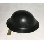 A WW2 British Steel Combat Helmet. Complete with its original 1943 dated liner and webbing