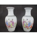 A pair of Chinese vases hand painted with traditional scenes, height 35cm