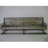 A large garden bench with cast iron ends and supports, approx. width 280cm