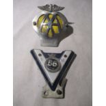 A vintage VM car badge for 1956 along with an AA badge