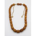 A vintage bakelite necklace resembling butterscotch amber