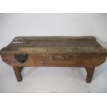 A large wooden workbench with "record" vice & two drawers