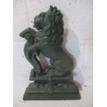 A late 19th Century cast iron door stop In the form of a Lion Rampant, 38cm high