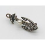 A small unmarked antique sweetheart brooch in the form of an anchor set with old cut diamonds and
